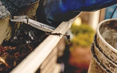cleaning gutters using efficient gutter cleaning tools